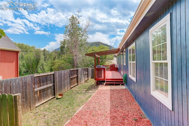 455 Clio Ave, Palmer Lake, CO 80133 - fenced backyard featuring a deck with mountain view