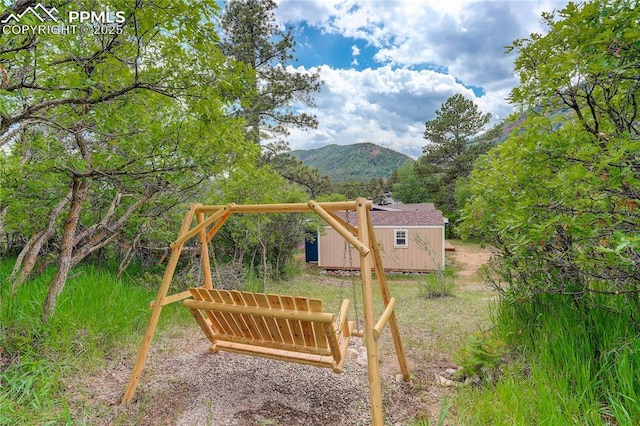 455 Clio Ave, Palmer Lake, CO 80133 - view of yard featuring a mountain view and a storage shed