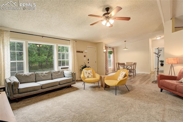 455 Clio Ave, Palmer Lake, CO 80133 - living area with a textured ceiling, ceiling fan, carpet flooring, vaulted ceiling, and wood finished floors
