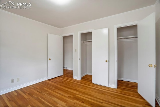 unfurnished bedroom with baseboards and wood finished floors