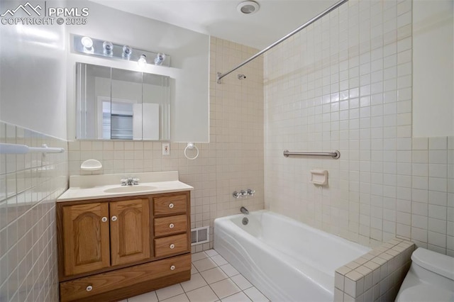 bathroom featuring tile patterned flooring, toilet, shower / bath combination, tile walls, and visible vents