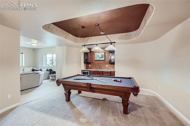 game room featuring visible vents, pool table, a tray ceiling, and light carpet