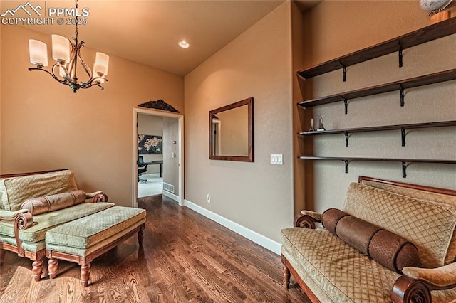 sitting room with baseboards, recessed lighting, dark wood-style flooring, and a notable chandelier