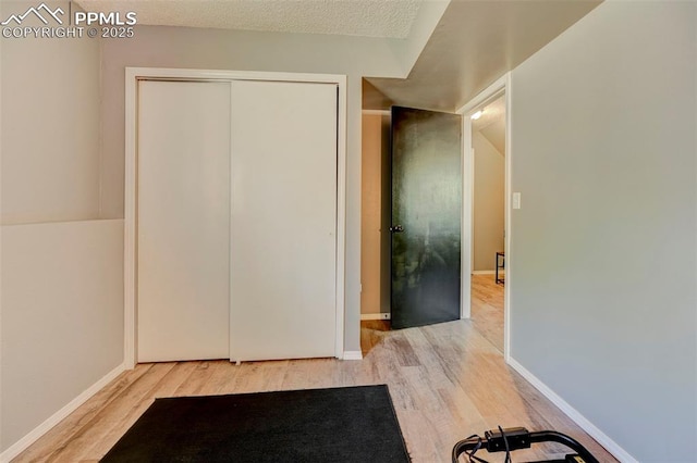 interior space featuring wood finished floors and baseboards