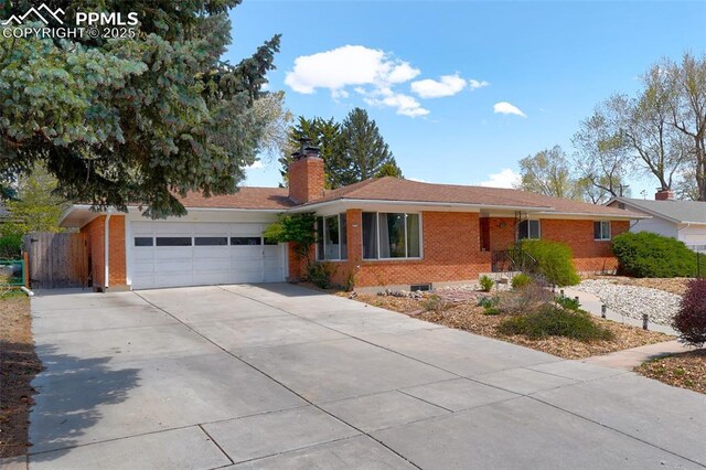 ranch-style house with brick siding, driveway, a chimney, and a garage
