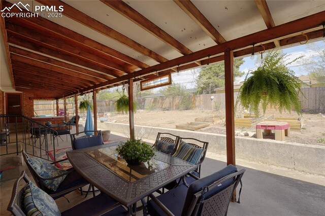 view of patio / terrace featuring fence and outdoor dining space