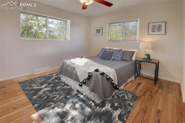 1227 Holmes Dr, Colorado Springs, CO 80909 - bedroom with multiple windows, wood finished floors, and baseboards
