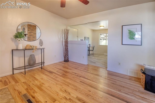 1227 Holmes Dr, Colorado Springs, CO 80909 - living room featuring wood finished floors, a ceiling fan, and baseboards