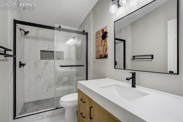 869 Kiowa Rd, Florissant, CO 80816 - bathroom featuring toilet, a marble finish shower, marble look tile flooring, and vanity