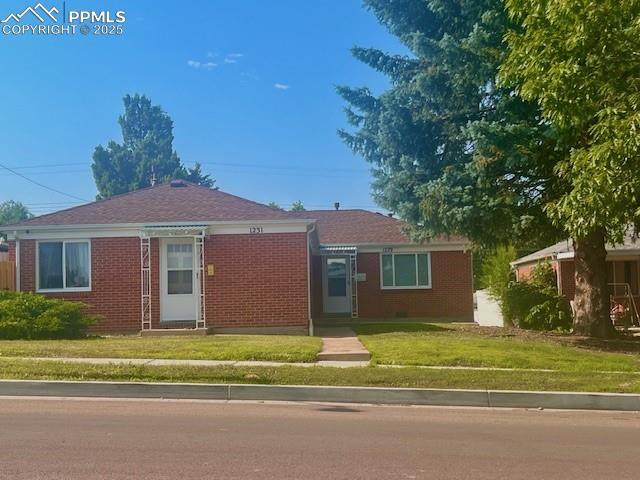 1229 E Caramillo St, Colorado Springs, CO 80909 - single story home featuring a front yard and brick siding