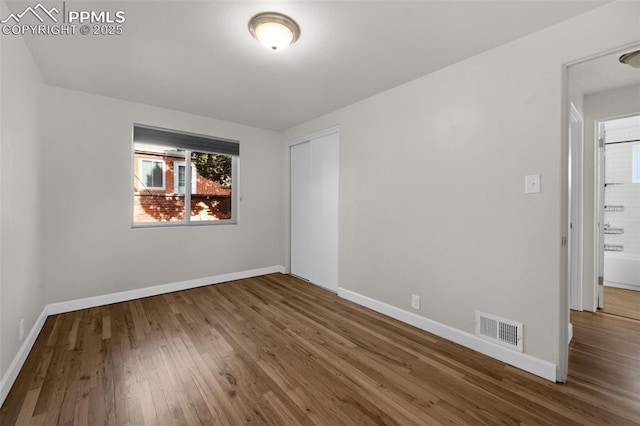 1229 E Caramillo St, Colorado Springs, CO 80909 - empty room featuring wood finished floors, healthy amount of natural light, and baseboards
