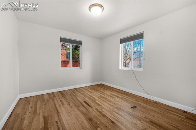 1229 E Caramillo St, Colorado Springs, CO 80909 - empty room featuring wood finished floors and baseboards