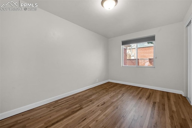1229 E Caramillo St, Colorado Springs, CO 80909 - empty room featuring hardwood / wood-style floors and baseboards
