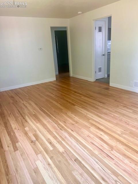 1229 E Caramillo St, Colorado Springs, CO 80909 - empty room with light wood finished floors and baseboards