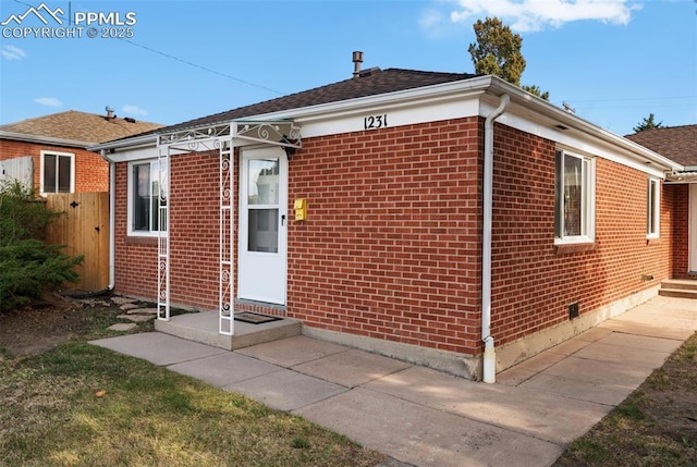 1229 E Caramillo St, Colorado Springs, CO 80909 - rear view of house featuring brick siding and fence