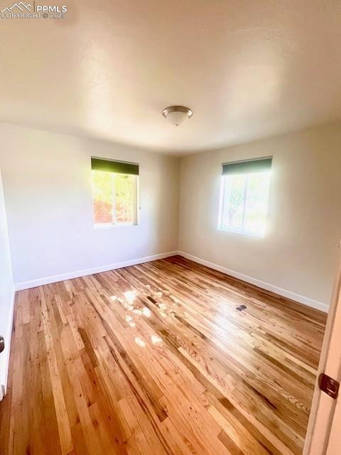 1229 E Caramillo St, Colorado Springs, CO 80909 - empty room featuring wood finished floors and baseboards