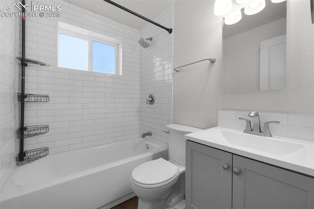 1229 E Caramillo St, Colorado Springs, CO 80909 - full bathroom featuring toilet, vanity, tub / shower combination, and a textured wall