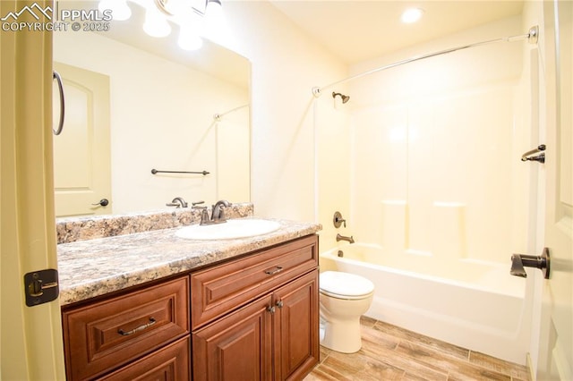 full bathroom with vanity, shower / bathing tub combination, wood finished floors, and toilet