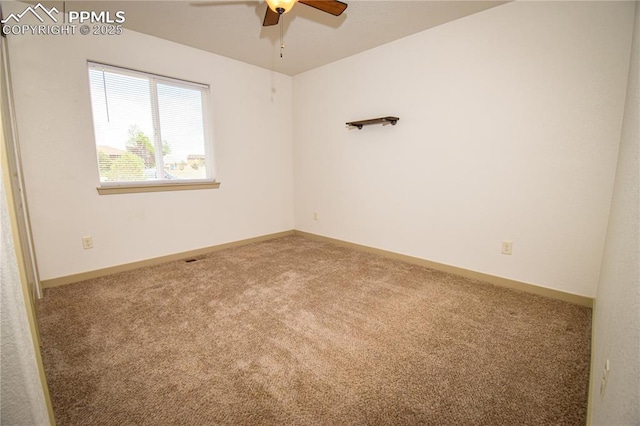 empty room featuring baseboards, a ceiling fan, and carpet