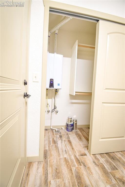 interior space featuring water heater and light wood-type flooring