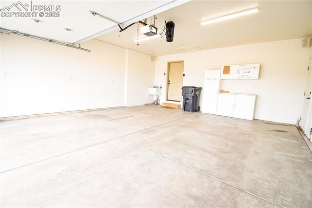 garage featuring a sink and a garage door opener