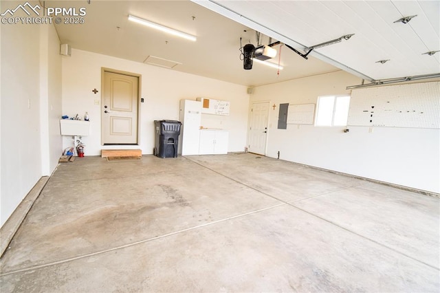 garage featuring a garage door opener and electric panel