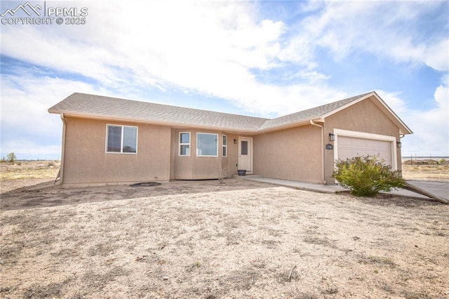 single story home featuring an attached garage and stucco siding