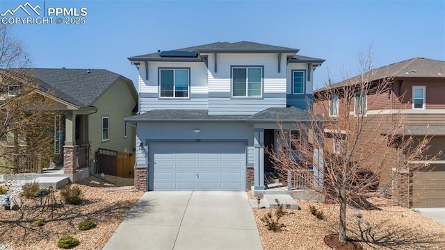 3111 Youngheart Way, Castle Rock, CO 80109 - prairie-style house with concrete driveway, solar panels, an attached garage, and a shingled roof