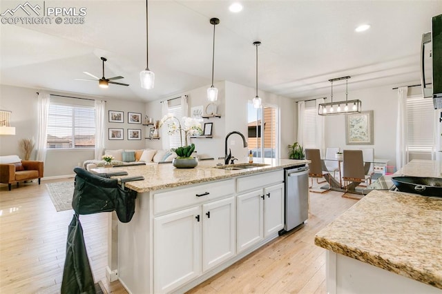 3111 Youngheart Way, Castle Rock, CO 80109 - kitchen with a sink, dishwasher, open floor plan, white cabinetry, and light wood-type flooring