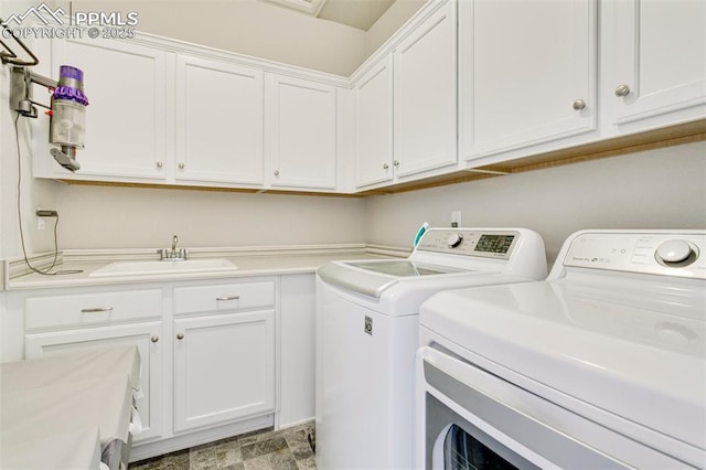 3111 Youngheart Way, Castle Rock, CO 80109 - laundry room with cabinet space, washing machine and clothes dryer, and light stone finish flooring