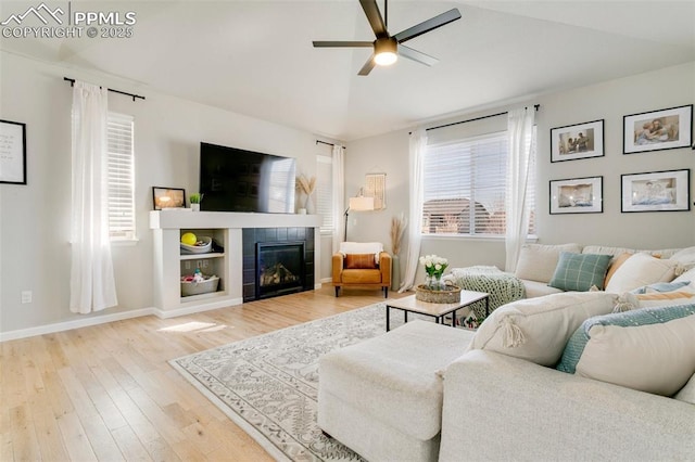3111 Youngheart Way, Castle Rock, CO 80109 - living room featuring ceiling fan, wood finished floors, a tiled fireplace, and baseboards