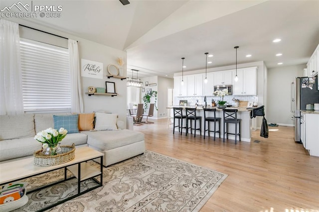 3111 Youngheart Way, Castle Rock, CO 80109 - living room with light wood-style floors, recessed lighting, lofted ceiling, and baseboards