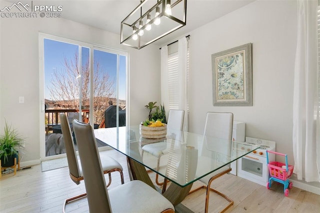 3111 Youngheart Way, Castle Rock, CO 80109 - dining area featuring wood finished floors, a chandelier, and baseboards