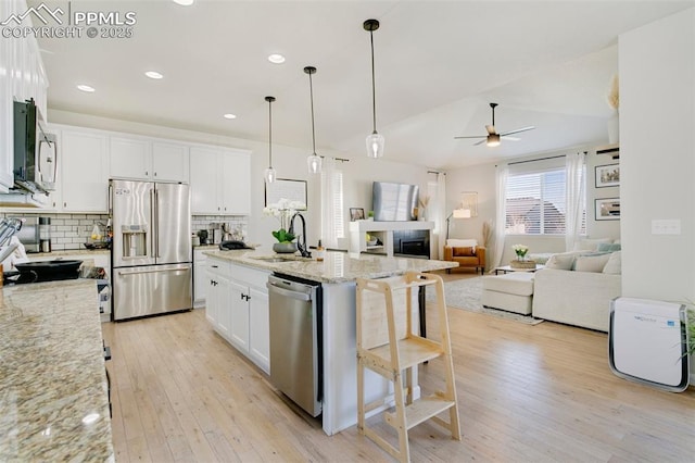 3111 Youngheart Way, Castle Rock, CO 80109 - kitchen featuring stainless steel appliances, a sink, ceiling fan, light wood-style floors, and recessed lighting