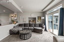 living room with baseboards and carpet flooring