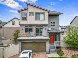 view of front of house with a garage, fence, and driveway