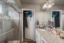 bathroom with vanity and a stall shower