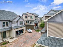exterior space with a residential view, an attached garage, and driveway