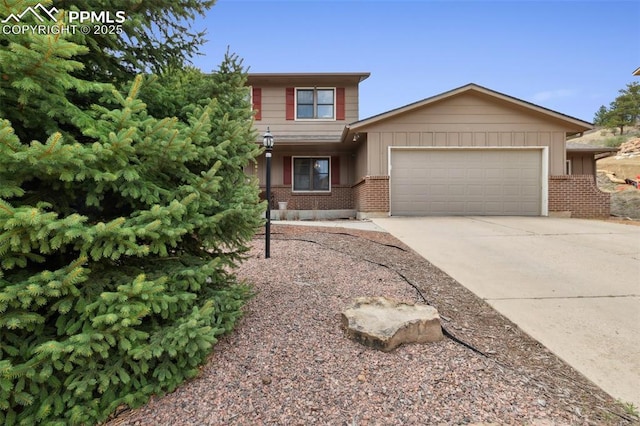 6820 Dauntless Ct, Colorado Springs, CO 80919 - view of front facade featuring brick siding, a garage, board and batten siding, and driveway