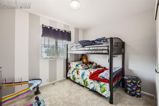 bedroom with visible vents, carpet, and baseboards