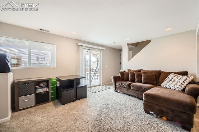 carpeted living room featuring visible vents, recessed lighting, and baseboards