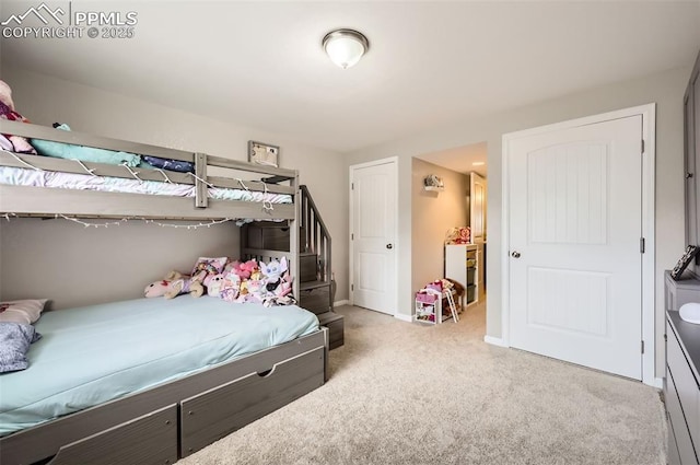 bedroom featuring baseboards and carpet