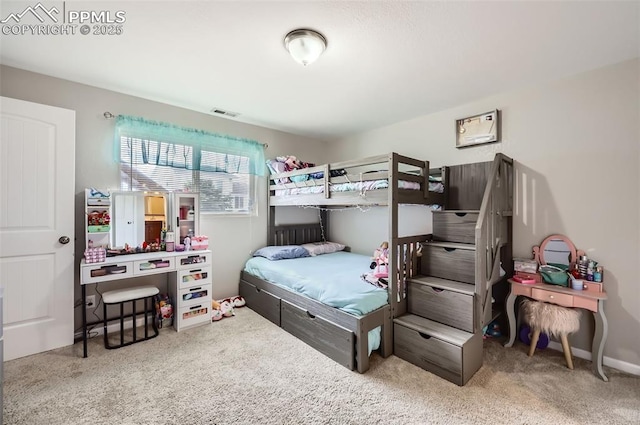 carpeted bedroom featuring visible vents