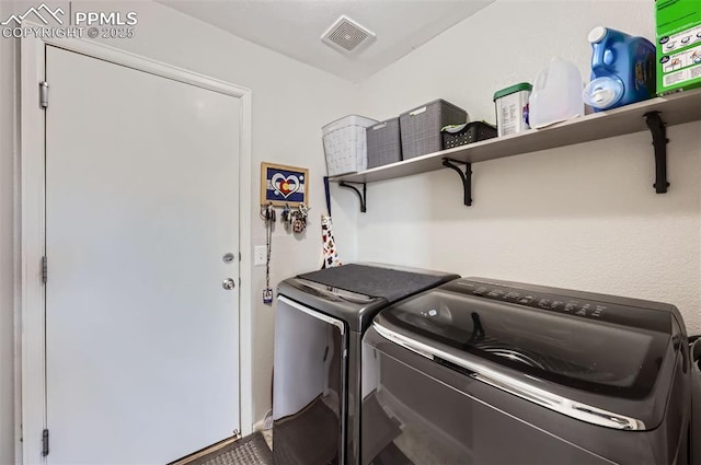 laundry area featuring washer and dryer, laundry area, and visible vents