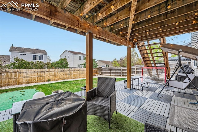 view of patio / terrace featuring a fenced backyard, a wooden deck, grilling area, and stairway