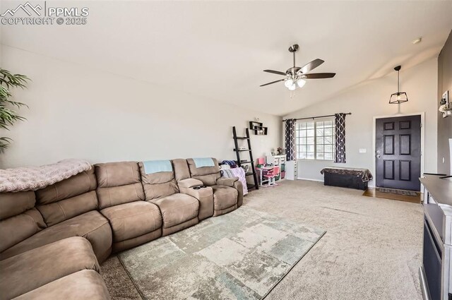 living room featuring vaulted ceiling, baseboards, ceiling fan, and carpet flooring