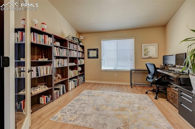 office featuring baseboards and wood finished floors