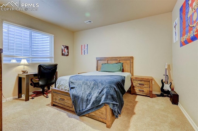 bedroom with baseboards, visible vents, and carpet