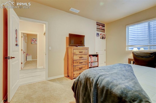 bedroom featuring visible vents, baseboards, and light colored carpet