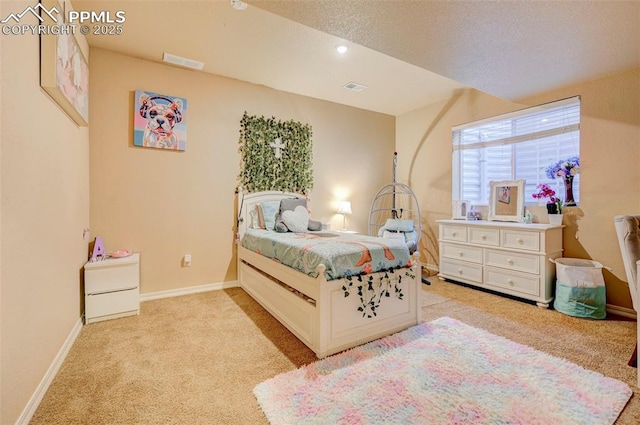 bedroom featuring baseboards, light colored carpet, and visible vents